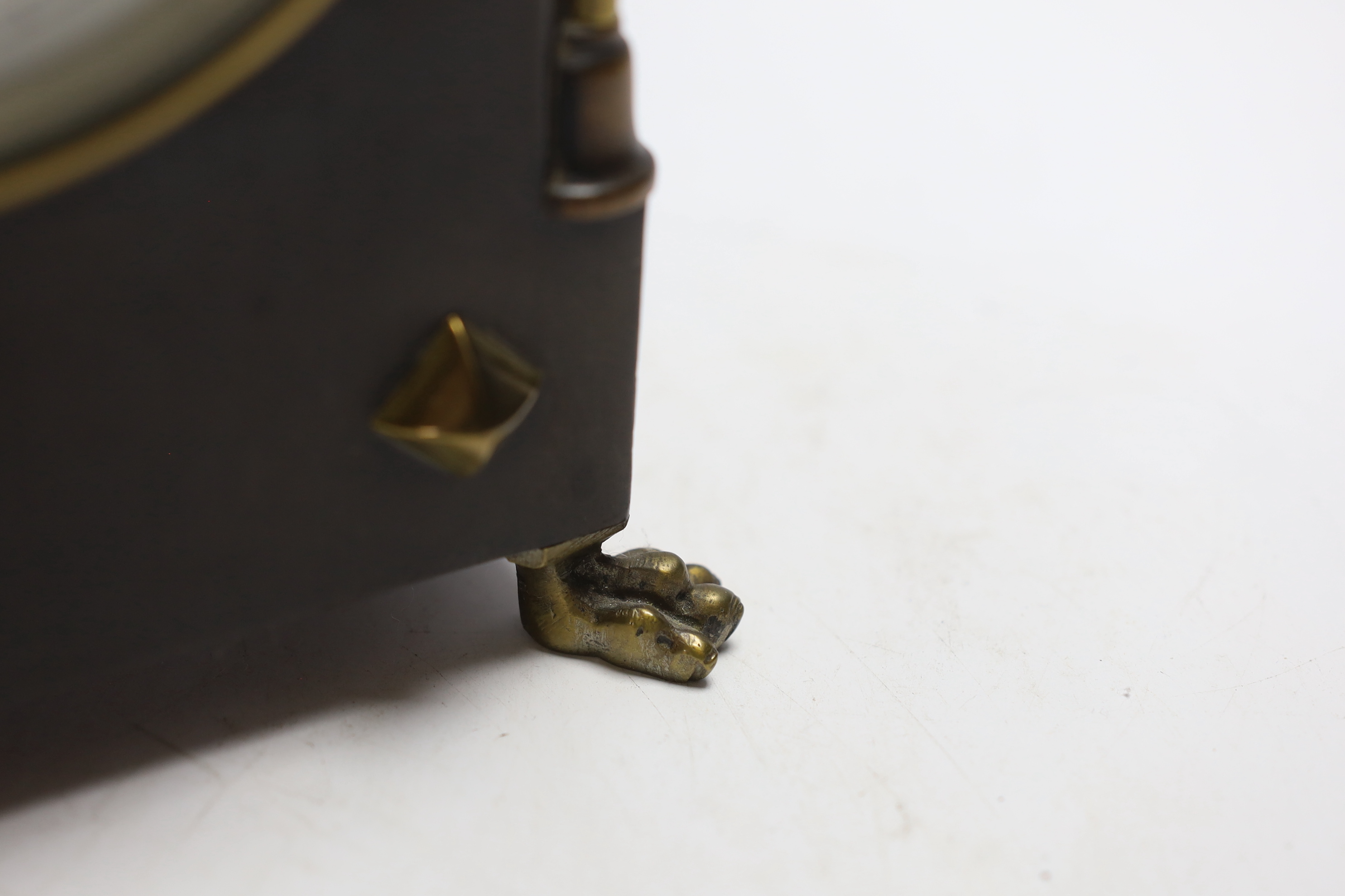 A small late 19th century ebonised mantel timepiece with studded case, 26cm